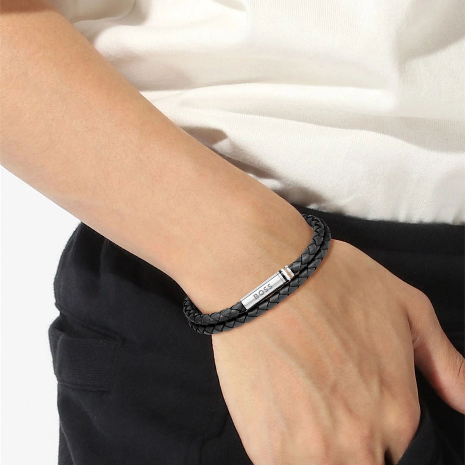 BOSS Ares black braided leather bracelet worn on wrist