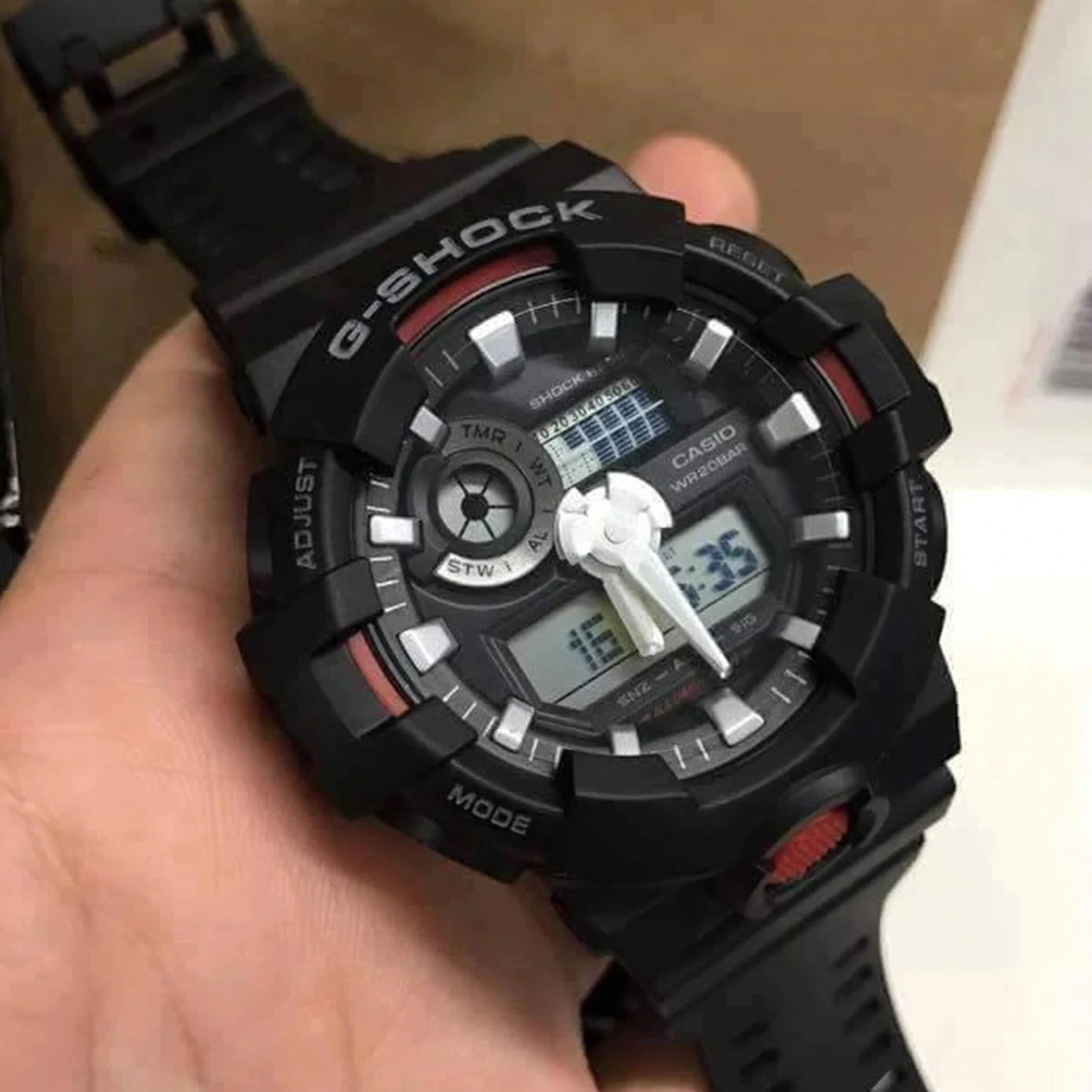 Casio G-Shock GA-700SF-1ADR watch held in hand showing dial detail