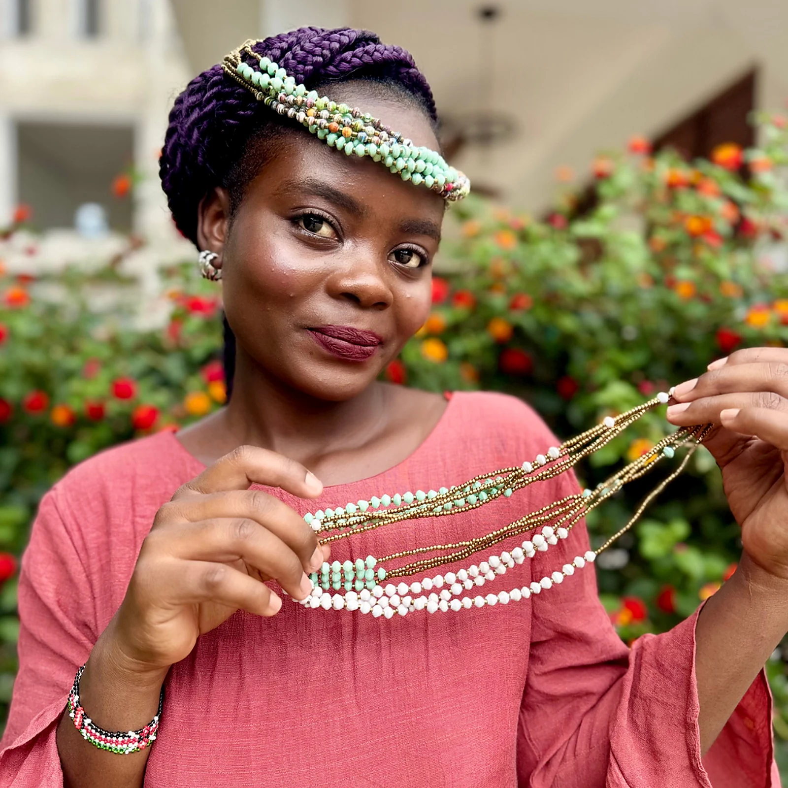 Model holding layered Wamama Wetu multicolour Kenyan head beads